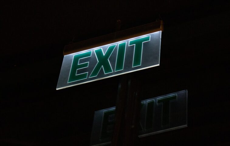 Illuminated exit sign glows brightly at night.