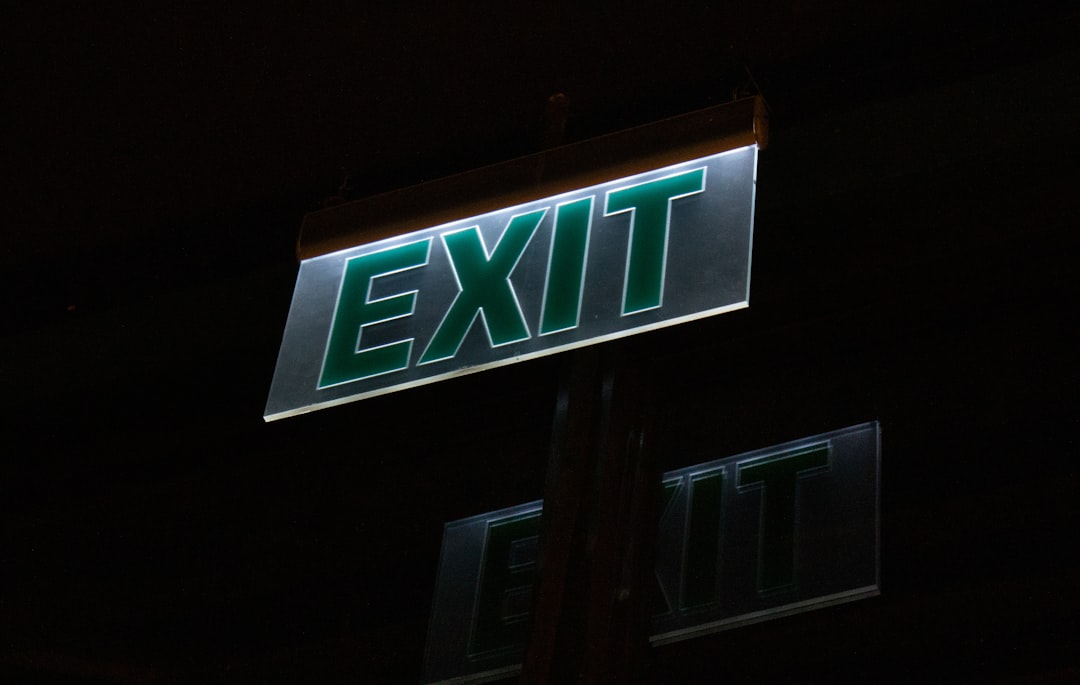 Illuminated exit sign glows brightly at night.